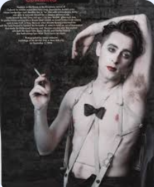 Alan Cumming smoking a cigarette as the MC in Cabaret